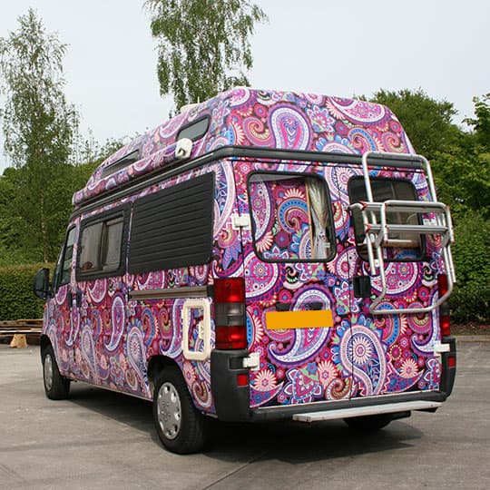 A custom printed full wrap camper van showcasing a vibrant and colourful design