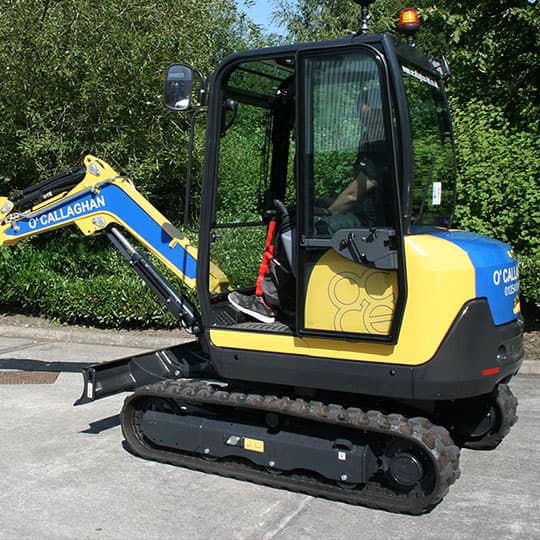 A small yellow and blue construction machine with cut and reflective vinyl vehicle graphics