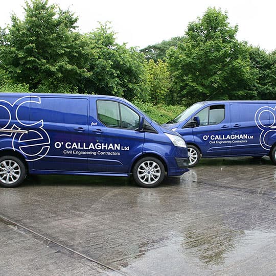 Two branded vans parked, showcasing a vehicle fleet with cut graphics